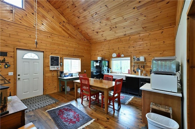 82912 Augustine Rd, Glidden, WI 54527 - dining area with plenty of natural light, wood walls, dark wood-style flooring, wood ceiling, and high vaulted ceiling