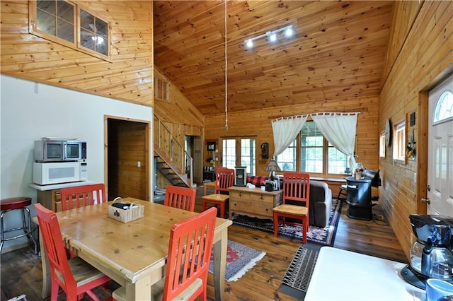 82912 Augustine Rd, Glidden, WI 54527 - dining space featuring wood-type flooring, stairs, high vaulted ceiling, and wood walls