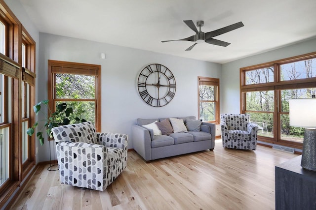 10 Prairie Hill Ct, Madison, WI 53719 - living area with light wood-style flooring, a ceiling fan, and baseboards