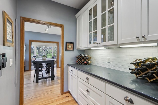 10 Prairie Hill Ct, Madison, WI 53719 - kitchen with backsplash, dark countertops, light wood-style floors, and white cabinetry