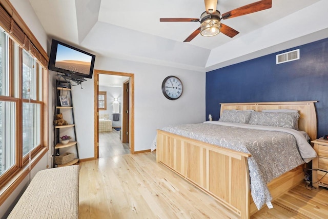 10 Prairie Hill Ct, Madison, WI 53719 - bedroom featuring a raised ceiling, light wood-style flooring, multiple windows, and baseboards