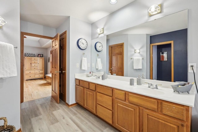10 Prairie Hill Ct, Madison, WI 53719 - ensuite bathroom with wood finished floors, double vanity, and baseboards