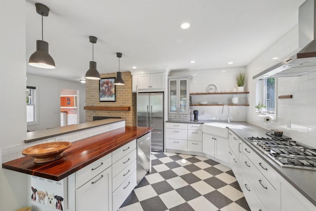 3910 Birch Ave, Madison, WI 53711 - kitchen featuring butcher block counters, open shelves, appliances with stainless steel finishes, a sink, and light floors