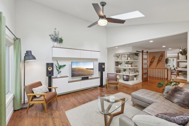 3910 Birch Ave, Madison, WI 53711 - living room with a skylight, wood finished floors, high vaulted ceiling, and ceiling fan