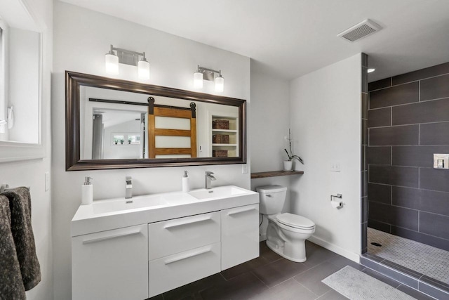 3910 Birch Ave, Madison, WI 53711 - full bathroom featuring double vanity, tiled shower, toilet, tile patterned floors, and baseboards