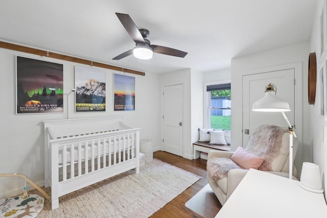 3910 Birch Ave, Madison, WI 53711 - bedroom featuring wood finished floors, ceiling fan, baseboards, and a crib