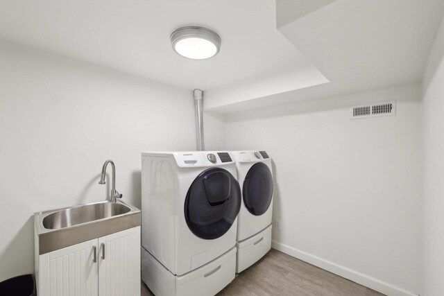 3910 Birch Ave, Madison, WI 53711 - laundry area with washer and dryer, cabinet space, light wood-style floors, and baseboards