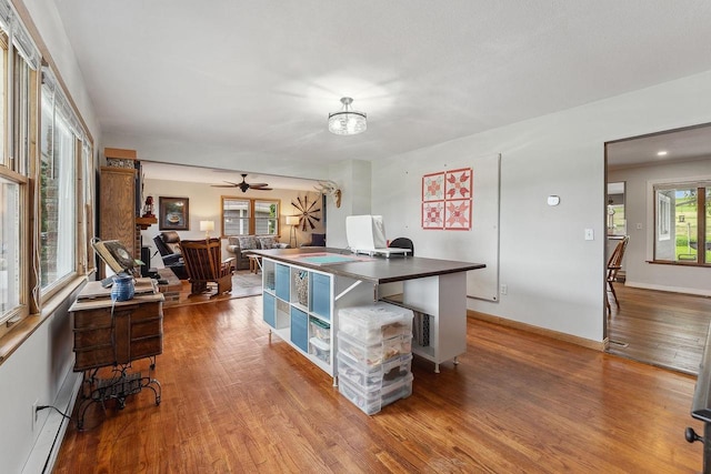 N3504 State Rd 80, Elroy, WI 53929 - office area featuring wood finished floors, ceiling fan, a baseboard heating unit, and baseboards