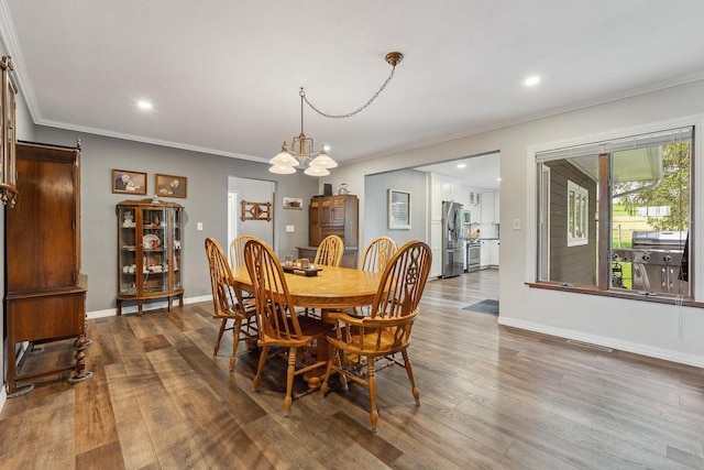 N3504 State Rd 80, Elroy, WI 53929 - dining room with ornamental molding, dark wood-style flooring, a chandelier, baseboards, and recessed lighting