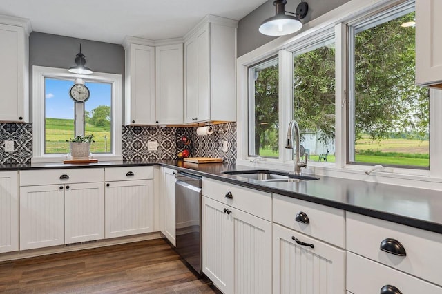 N3504 State Rd 80, Elroy, WI 53929 - kitchen with a sink, dishwasher, dark countertops, decorative backsplash, and white cabinetry