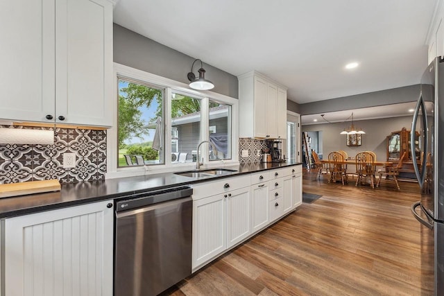 N3504 State Rd 80, Elroy, WI 53929 - kitchen with stainless steel appliances, a sink, dark countertops, dark wood finished floors, and backsplash