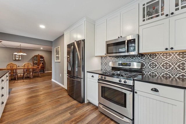 N3504 State Rd 80, Elroy, WI 53929 - kitchen with stainless steel appliances, dark countertops, dark wood finished floors, white cabinetry, and tasteful backsplash