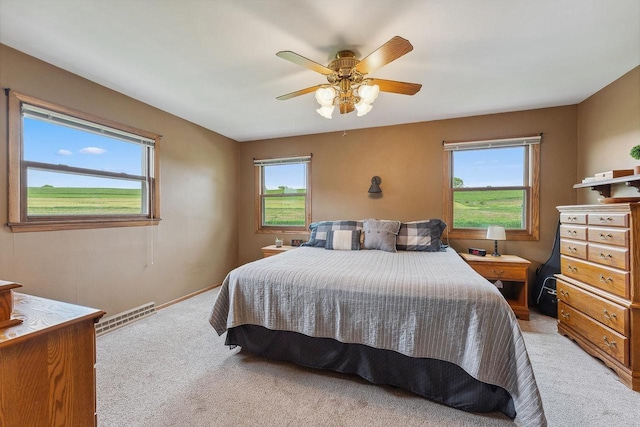 N3504 State Rd 80, Elroy, WI 53929 - bedroom with light carpet, ceiling fan, and baseboards