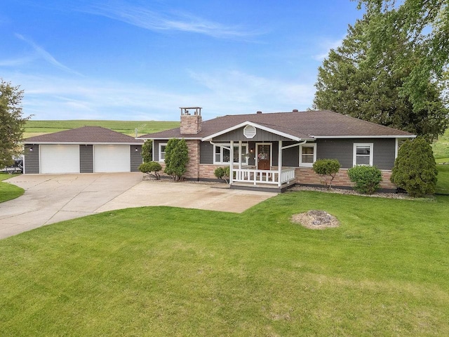 N3504 State Rd 80, Elroy, WI 53929 - view of front of home with a porch, an outbuilding, a garage, a front lawn, and a chimney