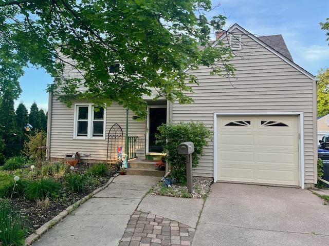 1842 Hubbard St, Oshkosh, WI 54902 - obstructed view of property with driveway and an attached garage