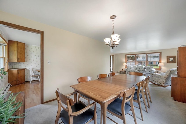 108 S Clay St, De Pere, WI 54115 - dining room featuring a chandelier, light carpet, a baseboard radiator, and baseboards