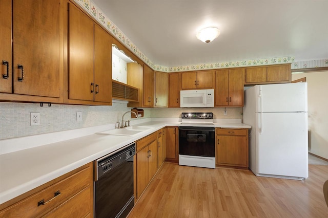 108 S Clay St, De Pere, WI 54115 - kitchen with white appliances, a sink, and brown cabinets