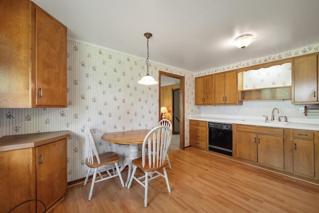 108 S Clay St, De Pere, WI 54115 - kitchen featuring black dishwasher, wallpapered walls, a sink, light wood-style flooring, and brown cabinetry