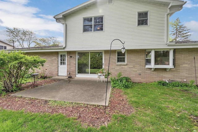 108 S Clay St, De Pere, WI 54115 - back of house featuring brick siding, a patio, and a lawn