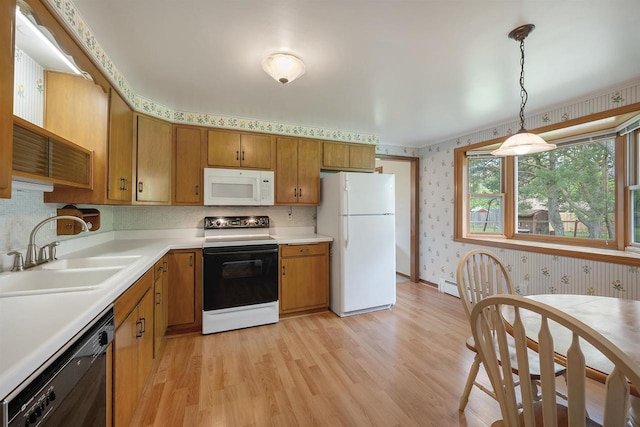 108 S Clay St, De Pere, WI 54115 - kitchen featuring white appliances, wallpapered walls, a sink, light wood-type flooring, and light countertops