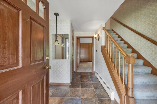 108 S Clay St, De Pere, WI 54115 - entryway with a baseboard radiator, wallpapered walls, stairway, dark stone finish flooring, and baseboards