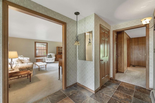 108 S Clay St, De Pere, WI 54115 - hall with baseboards, dark stone finish floors, a baseboard heating unit, and dark carpet