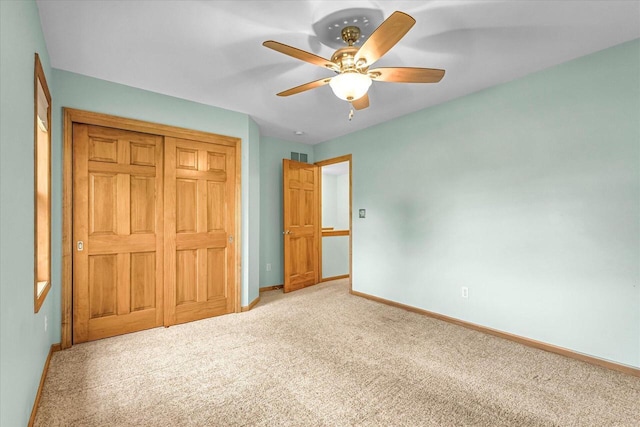 N74W28801 Zimmers Xing, Hartland, WI 53029 - unfurnished bedroom with baseboards, light carpet, a closet, and a ceiling fan