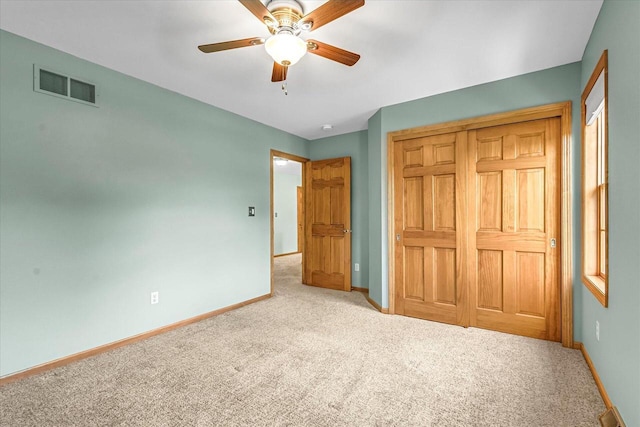 N74W28801 Zimmers Xing, Hartland, WI 53029 - unfurnished bedroom featuring carpet flooring, baseboards, a closet, and a ceiling fan