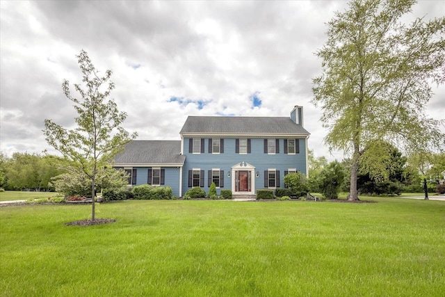N74W28801 Zimmers Xing, Hartland, WI 53029 - colonial inspired home featuring a chimney and a front lawn
