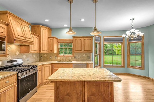 N74W28801 Zimmers Xing, Hartland, WI 53029 - kitchen with appliances with stainless steel finishes, a sink, light wood-type flooring, healthy amount of natural light, and recessed lighting