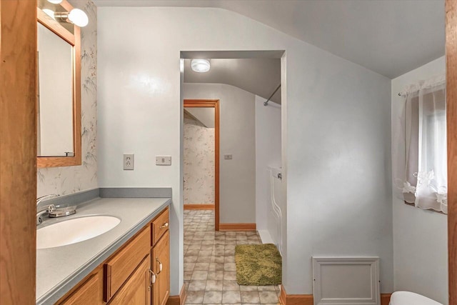 1416 Lake Dr, South Milwaukee, WI 53172 - full bath featuring vaulted ceiling, vanity, tile patterned floors, toilet, and baseboards