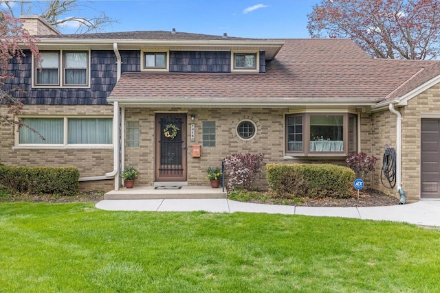 1416 Lake Dr, South Milwaukee, WI 53172 - view of front facade with a front yard, an attached garage, and a shingled roof