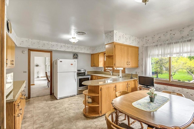1416 Lake Dr, South Milwaukee, WI 53172 - kitchen with white appliances, open shelves, wallpapered walls, a peninsula, and light countertops
