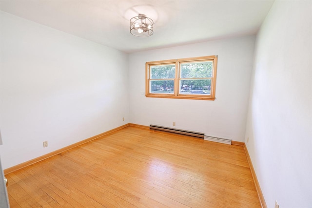 3023 Park Ave, Beloit, WI 53511 - empty room with light wood finished floors, a chandelier, and baseboards