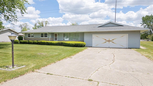3023 Park Ave, Beloit, WI 53511 - ranch-style home with a front yard, concrete driveway, an attached garage, and roof with shingles