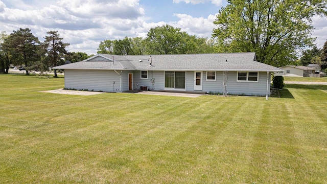 3023 Park Ave, Beloit, WI 53511 - rear view of property featuring a patio area, a lawn, and a shingled roof