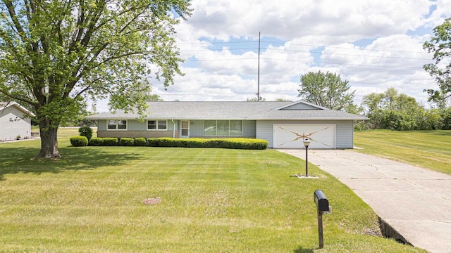 3023 Park Ave, Beloit, WI 53511 - ranch-style house with a garage, concrete driveway, and a front lawn