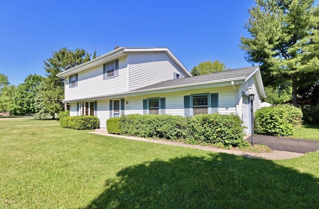 2221 E Easy St, Beloit, WI 53511 - traditional-style home featuring driveway, a front lawn, and an attached garage