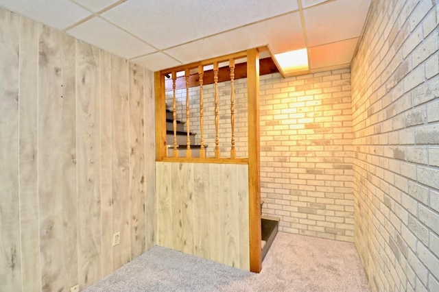2221 E Easy St, Beloit, WI 53511 - wine room featuring wood walls, brick wall, and carpet floors