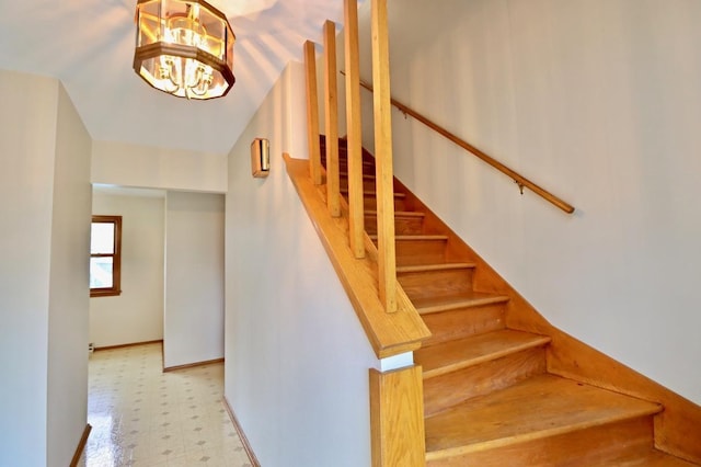 2221 E Easy St, Beloit, WI 53511 - stairway featuring tile patterned floors, lofted ceiling, a chandelier, and baseboards