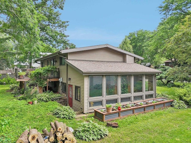 3604 Glenn Ln, Middleton, WI 53562 - back of property featuring a sunroom, roof with shingles, a wooden deck, and a lawn