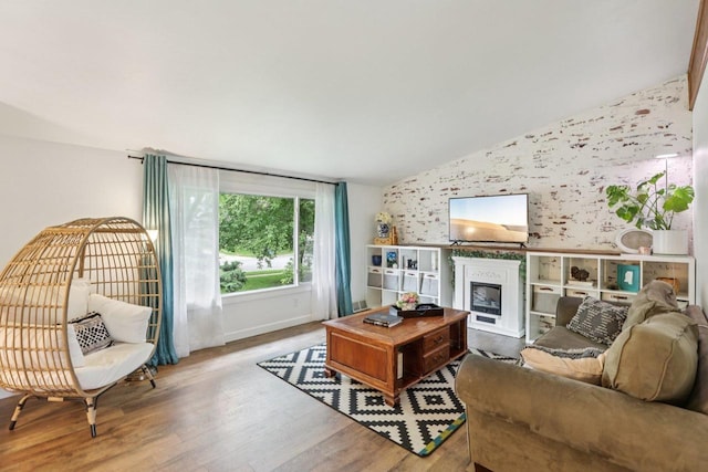 3604 Glenn Ln, Middleton, WI 53562 - living room with an accent wall, wallpapered walls, a fireplace, wood finished floors, and lofted ceiling