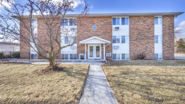 1106 S 7th St Unit 2, Sheboygan, WI 53081 - townhome / multi-family property featuring french doors, brick siding, and a front lawn
