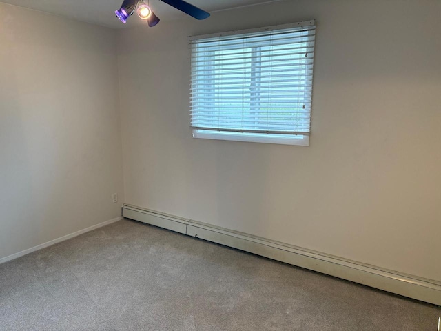 1106 S 7th St Unit 2, Sheboygan, WI 53081 - carpeted spare room featuring a baseboard heating unit, ceiling fan, and baseboards