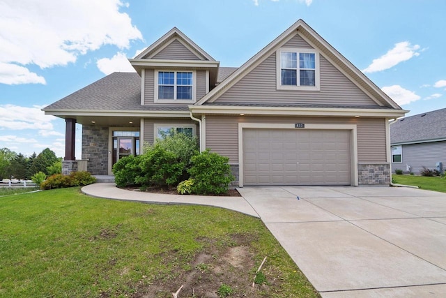 417 Champlain Dr, Johnson Creek, WI 53038 - craftsman-style house featuring stone siding, concrete driveway, a front lawn, and a garage
