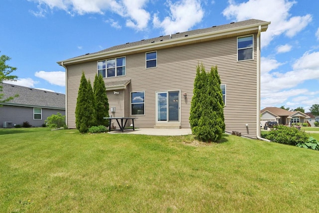 417 Champlain Dr, Johnson Creek, WI 53038 - rear view of house featuring a lawn, a patio area, and cooling unit