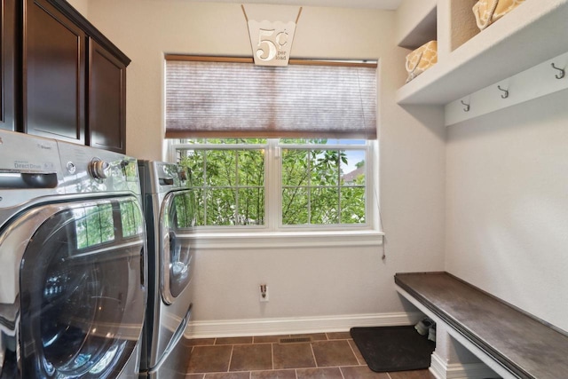 417 Champlain Dr, Johnson Creek, WI 53038 - laundry area with washing machine and dryer, cabinet space, baseboards, and dark tile patterned floors