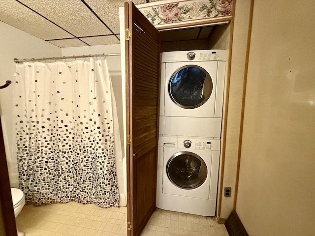 105 Cliff St, Camp Douglas, WI 54618 - laundry room featuring stacked washing machine and dryer and baseboards