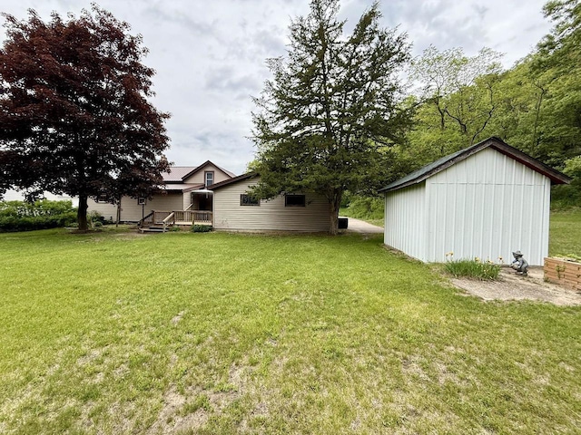 105 Cliff St, Camp Douglas, WI 54618 - view of green lawn featuring an outdoor structure and a deck