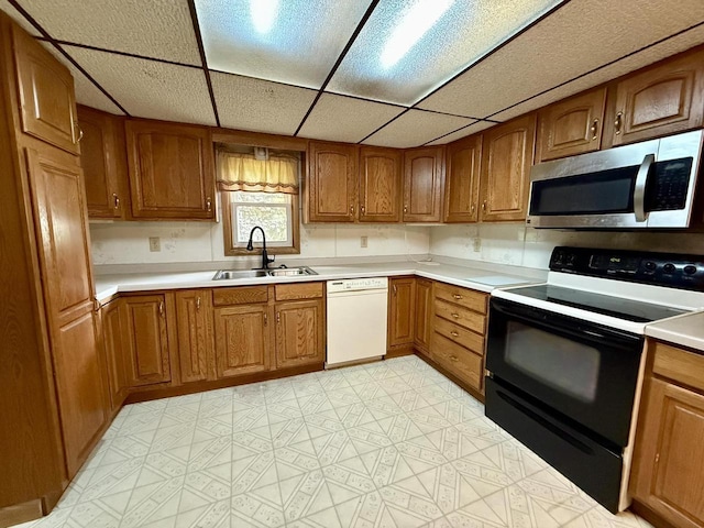 105 Cliff St, Camp Douglas, WI 54618 - kitchen with stainless steel microwave, range with electric cooktop, white dishwasher, a sink, and brown cabinets